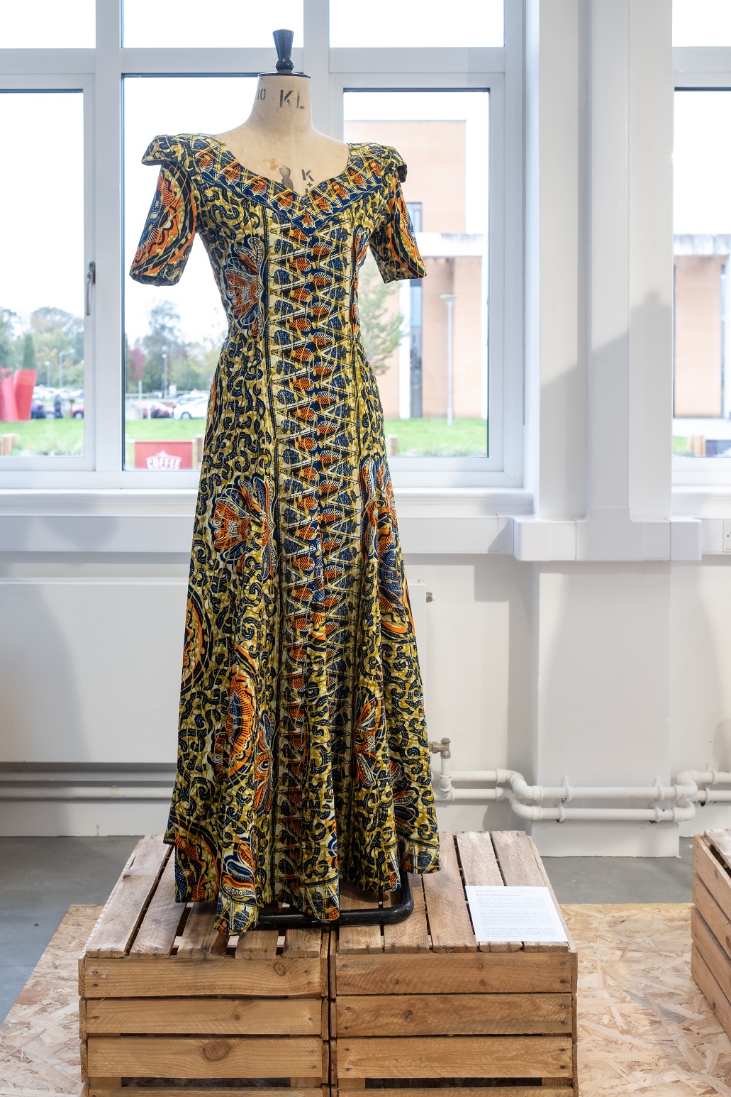 Nigerian party dress in varied bold colours on a mannequin 